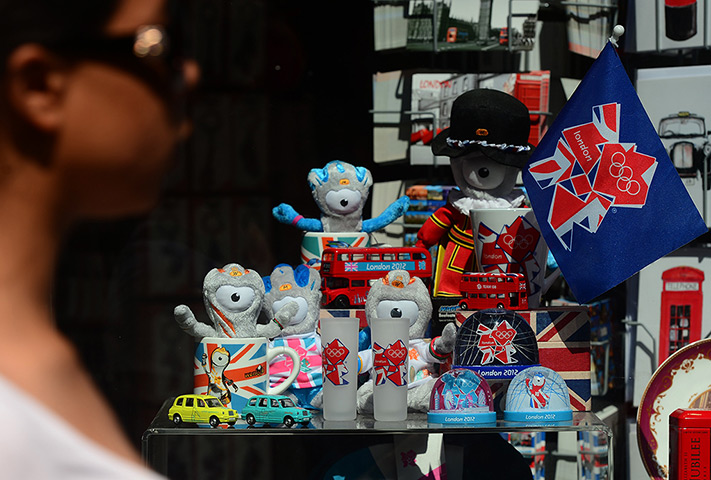 Year in Business: A woman walks by a shop displaying 2012 Olympic Games souvenirs