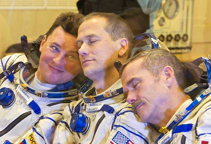 Lighter look: International Space Station crew members share a joke