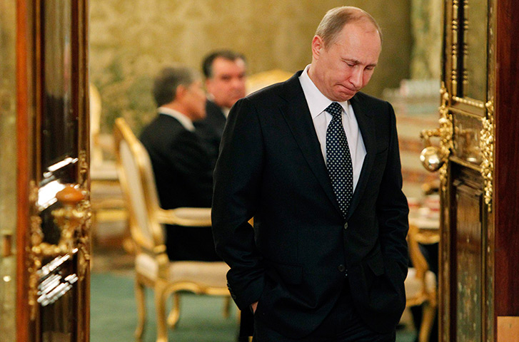 Lighter look: Russia's President Vladimir Putin waits