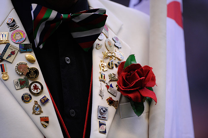 tom england v nz: Badges and a red rose on the jacket of the England mascot