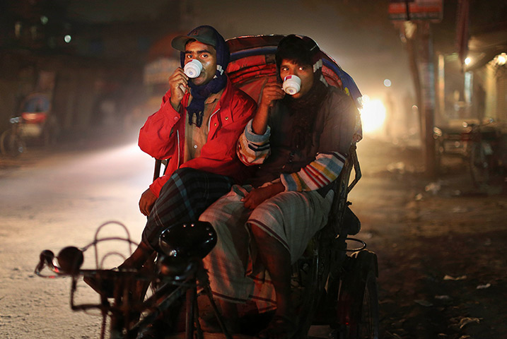 24 hours: Dhaka, Bangladesh: Bicycle rickshaw drivers drink tea