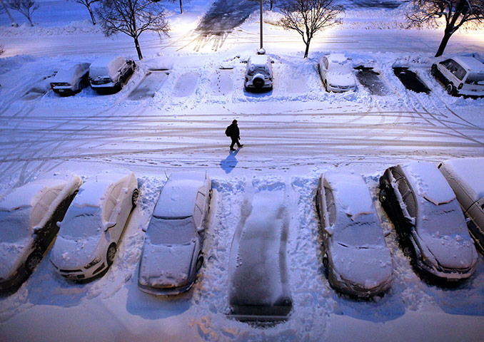 24 hours in pictures: Snow-covered cars in a car park