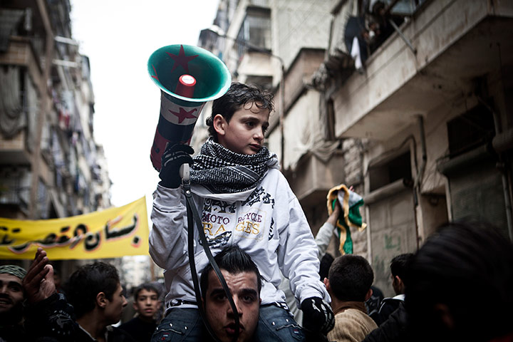 24 hours: A boy carries a megaphone during a protest