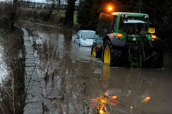 Wet weather: A car is towed from floodwater at Milby, northern England 