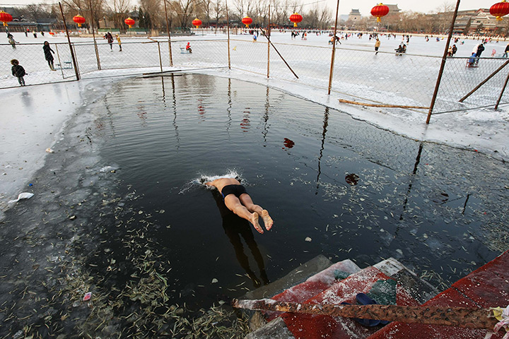 24 hours: Beijing, China: A winter swimmer jumps into the icy water 