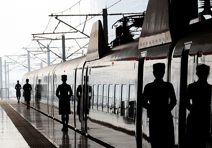 24 hours: Zhengzhou, China: Stewardesses stand by G55002 high-speed train