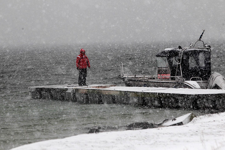 Living in a freezer: Rita Koppel stands on the pier during snowfall