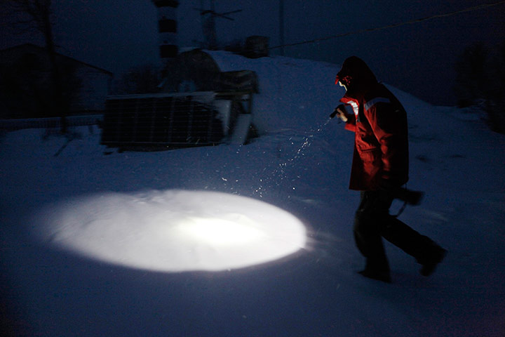Living in a freezer: Koppel holds a torch as she walks to the cellar in Osmussaar island