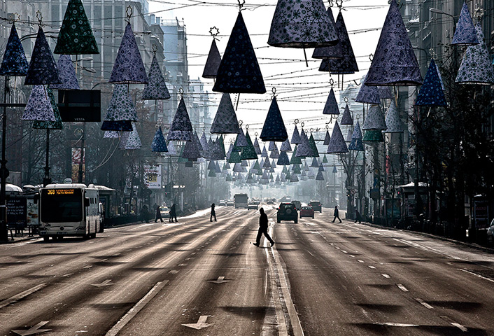 24 hours in pictures: A man crosses an almost deserted boulevard, Romania
