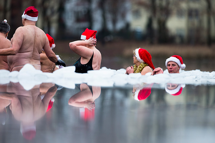 24 hours in pictures: Members of the Berlin Seals ice swimming club laugh in frozen Oranke Lake