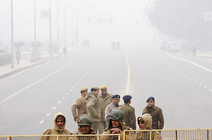 24 hours in pictures: Indian policemen block a road