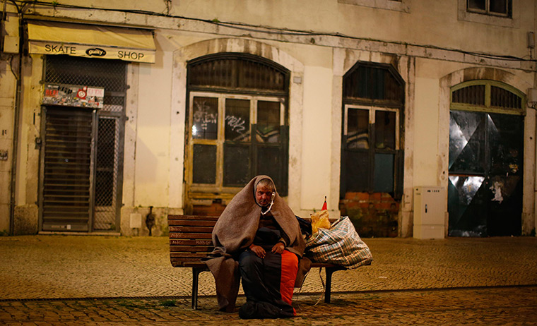 24 hours in pictures: A homeless man listens to his radio at Figueira square