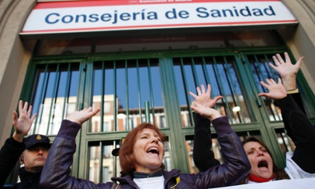 Demonstrators shout slogans during a protest against the local government's plans to cut spending on public health care, outside Madrid's health regional office in Madrid December 27, 2012. 