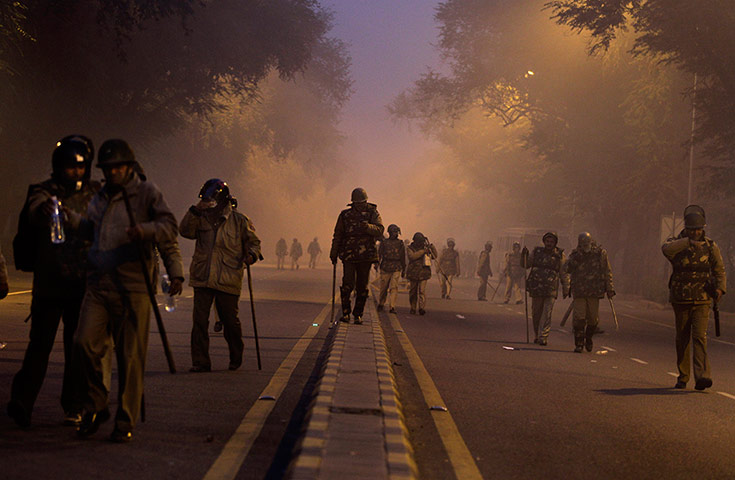 20 Photos: Policemen walk after chasing away protestors during a protest in New Delhi