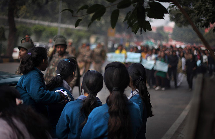 20 Photos: A group of school girls watch as Indian protesters demonstrate in New Delhi