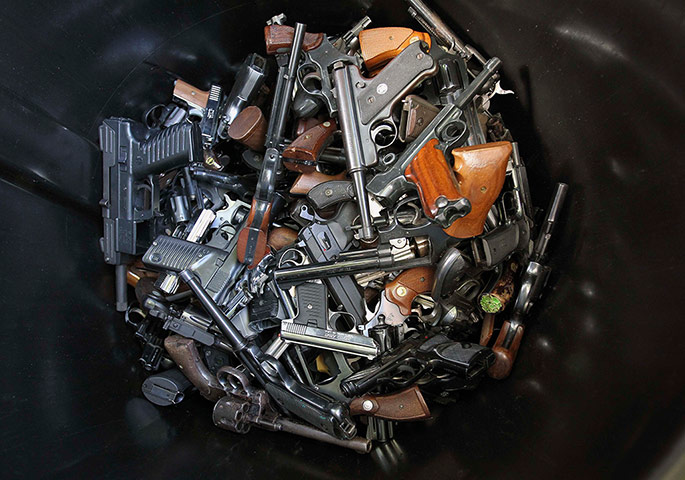 20 Photos: Hand guns that were surrendered are in a trash bin in Los Angeles