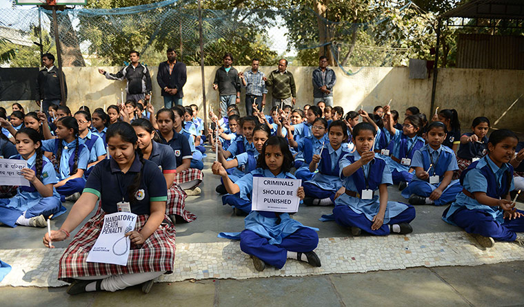 India: Indian schoolchildren hold placards and lighted candles