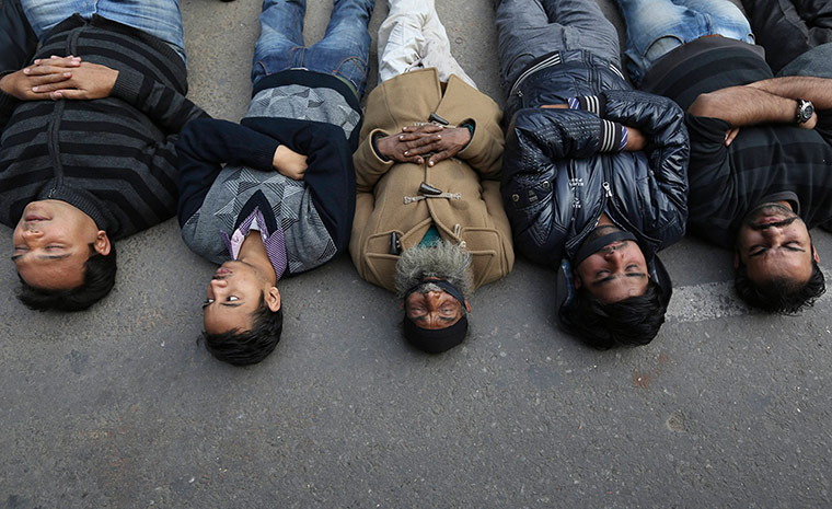 India: Demonstrators lie on a road during a protest in New Delhi