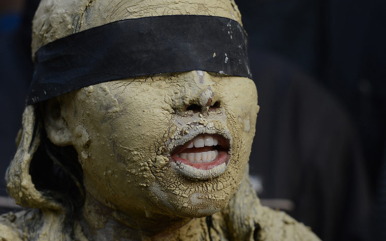 India: An Indian protestor covered in clay
