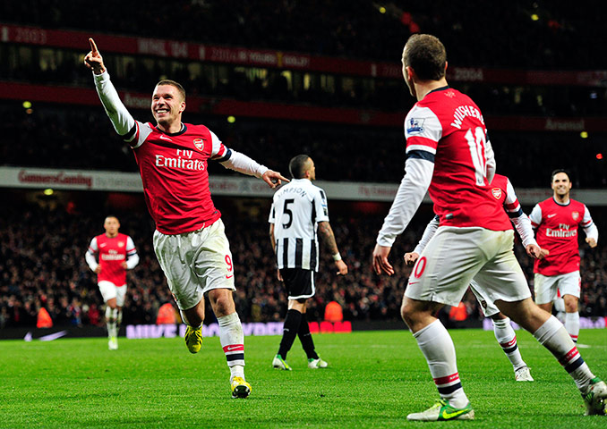 Saturday Sport Pictures: Arsenal's German striker Lukas Podolski celebrates scoring their third goal