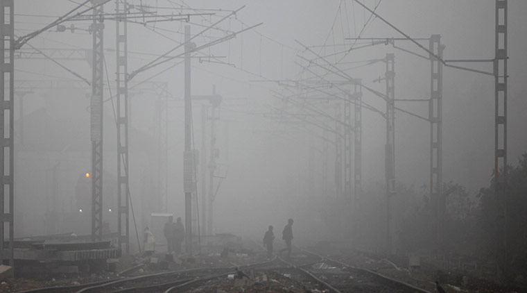 24 hours: People walk across railway tracks in the fog