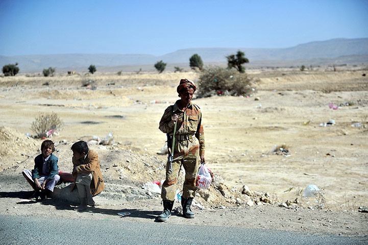 24 hours: Two boys sit next to a soldier
