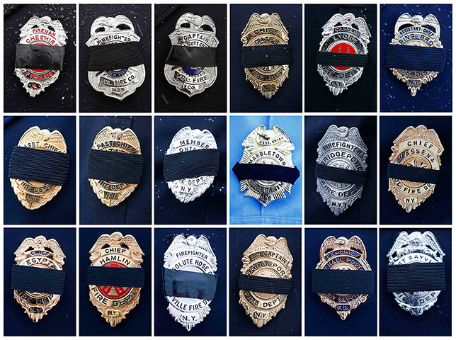 24 hours: Black mourning bands are seen on different fire department badges 