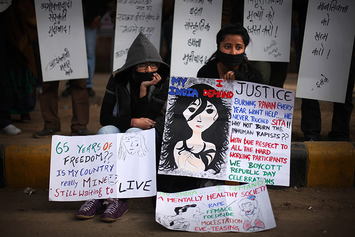 24 hours: Protesters sit on a sidewalk with placards during a protest
