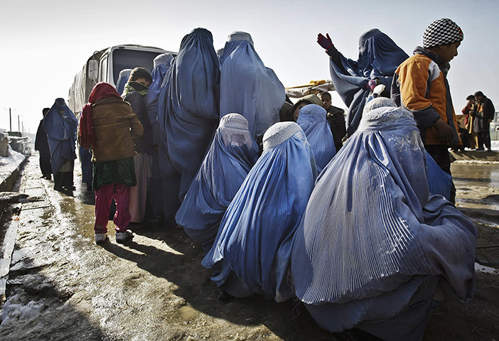 24 hours: Kabul, Afghanistan: Afghan women wait to receive winter relief assistance