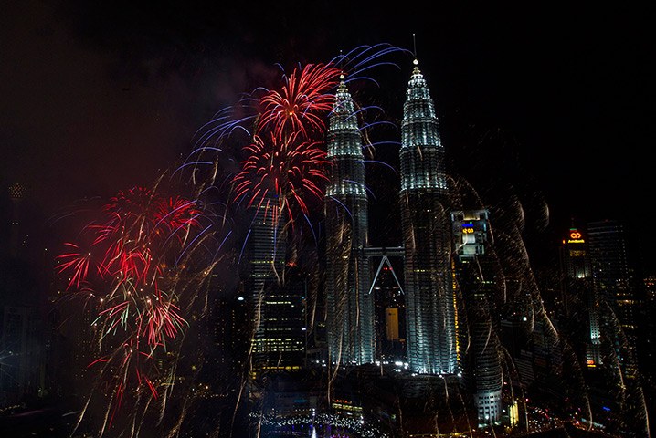 New year celebrations: fireworks explode near the Petronas Towers in Kuala Lumpur