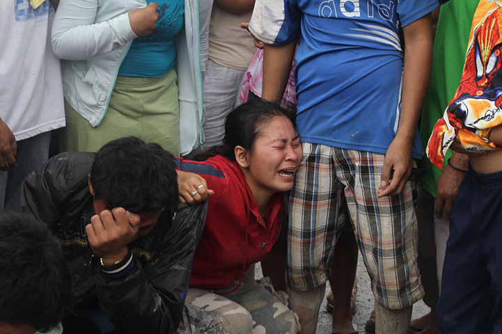 Typhoon Bopha: Relatives mourn as they identify bodies in the in New Bataan