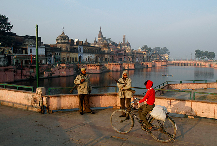 24 hours: Ayodhya, India: Police officers stand guard near a Hindu temple