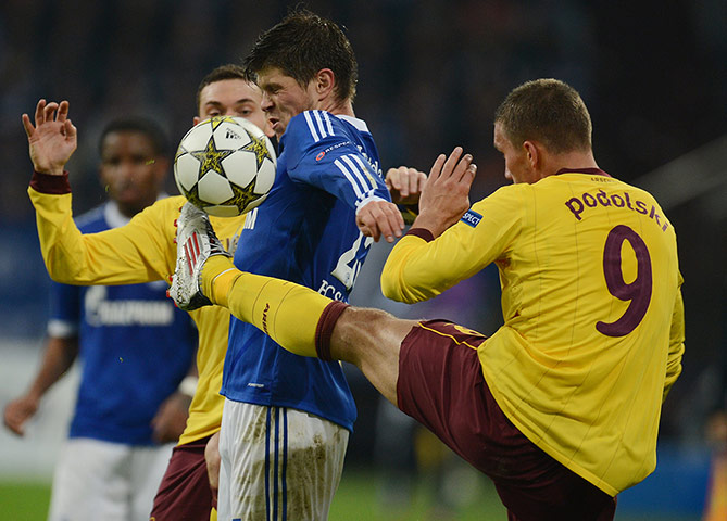 qualifiers: Schalke's Klaas-Jan Huntelaar and Arsenal's Lukas Podolski vie for the ball
