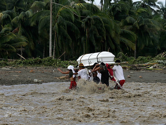 24 hours in pictures: Relatives cross a river with a coffin