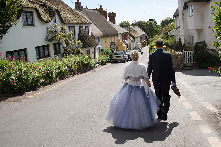 Your Pictures: quaint: Friends walk between venues at their wedding in Thurlestone