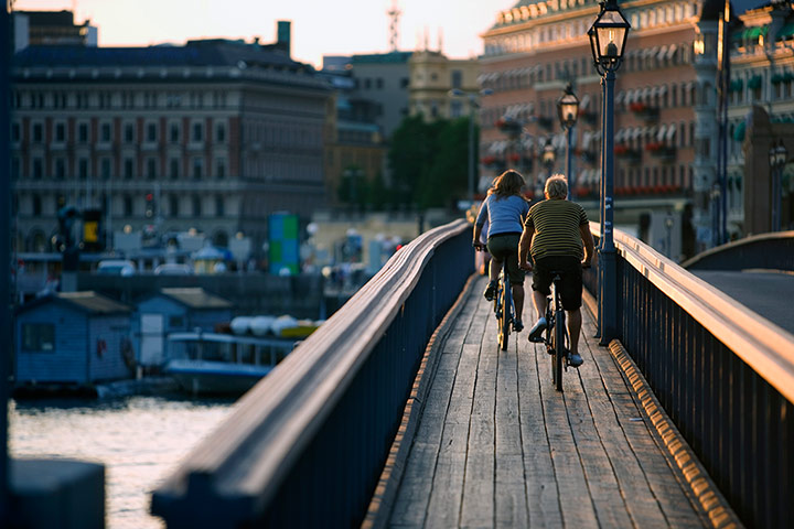 Healthiest cities: Stockholm cyclists crossing bridge