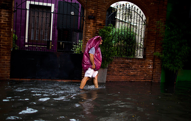 24 hours in pictures: A man wades through a flooded street in Buenos Aires, Argentina