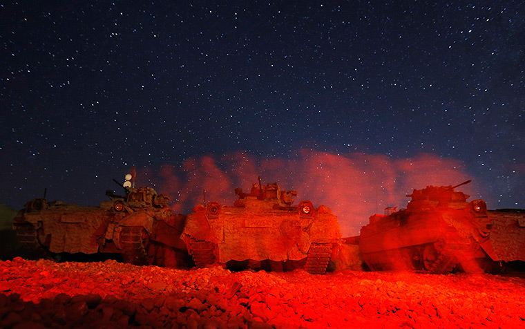 24 hours in pictures: German soldiers walk in front of an armoured personnel carrier in Baghlan, Afghanistan