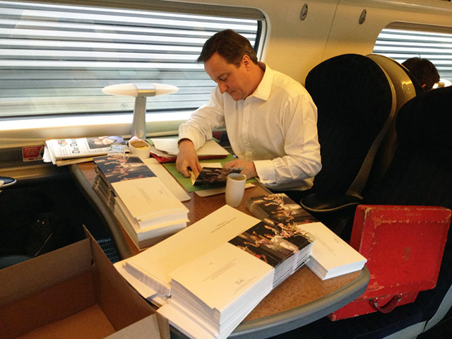 Political Christmas cards: David Cameron signs Christmas cards on a train