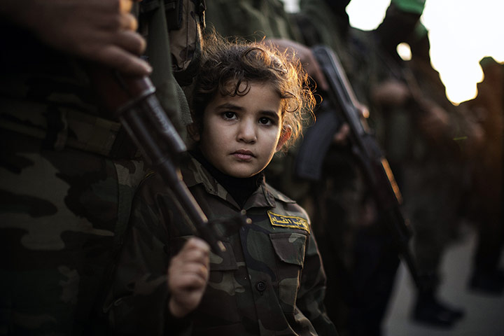 20 Photos: A Palestinian girl dressed as a Ezzedine al-Qassam brigade member