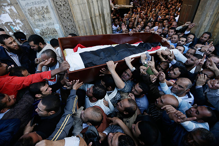 20 Photos: Muslim Brotherhood supporters carry a body during a funeral in Cairo