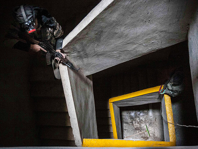 20 Photos: Free Syrian Army fighters aiming their weapons inside an abandoned building