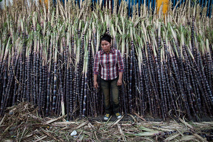24 hours:  A woman sells sugar cane in Managua, Nicaragua