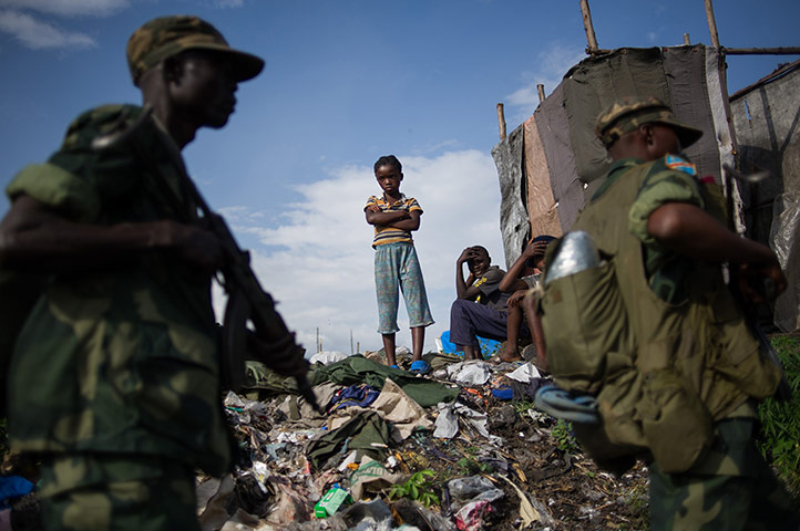 20 Photos: A child watches as Congolese government army soldiers return to Goma