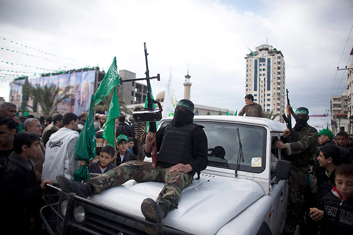 Hamas: Militants ride past crowds of Palestinians