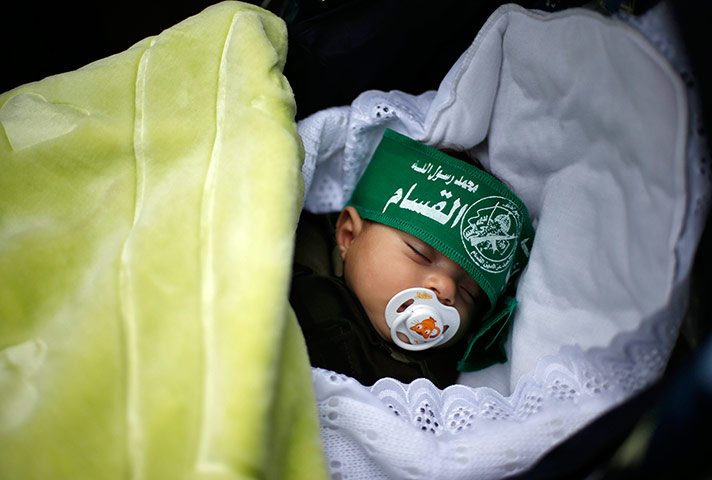 Hamas: A baby wearing a Hamas headband sleeps