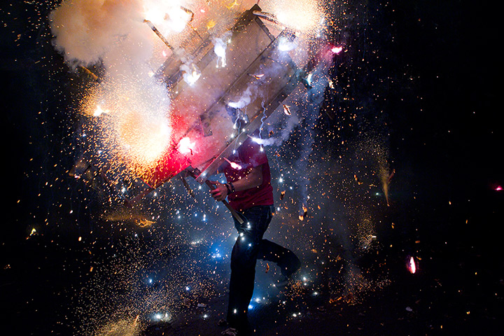 24 hours: Managua, Nicaragua: A man runs with a toro encuetado, a model bull covered in fireworks