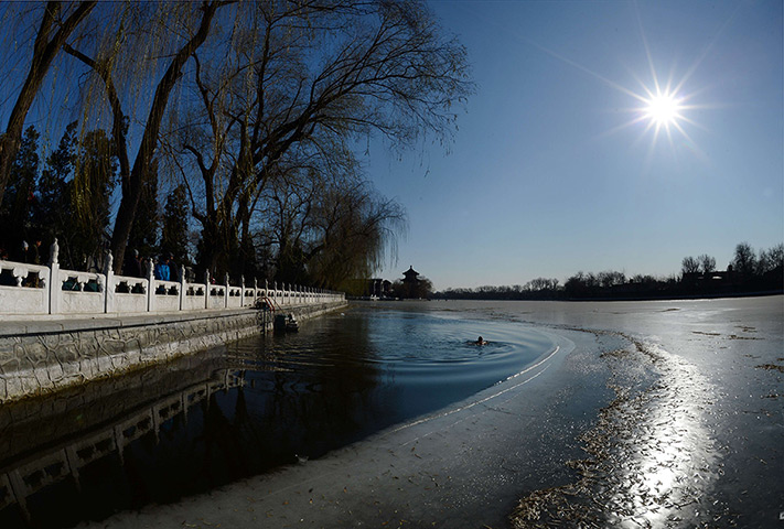 24 hours: Beijing, China: An ice swimmer in Houhai lake 