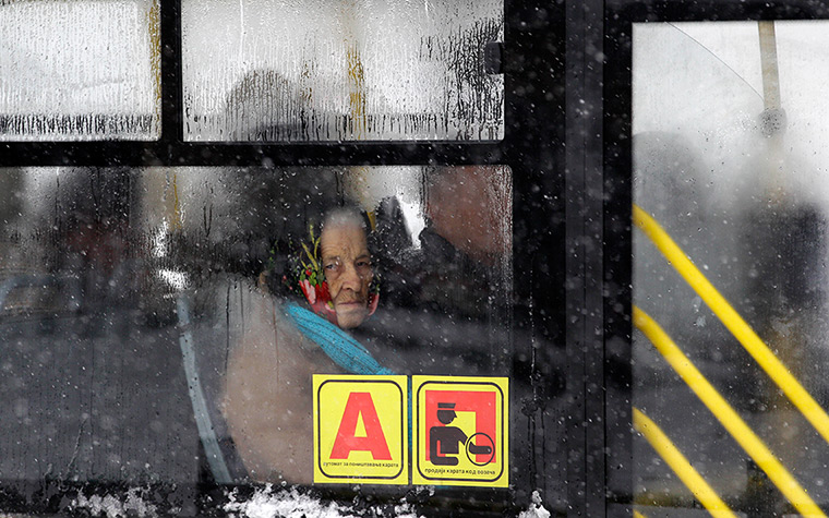 24 hours: Belgrade, Serbia: An elderly woman looks out of a bus window