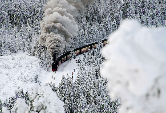24 hours: Wernigerode, Germany: A train on a narrow-gauge railway line steams through a snow-covered forest